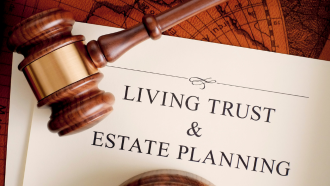 photo of a gavel and a piece of paper with the words "living trust & estate planning"